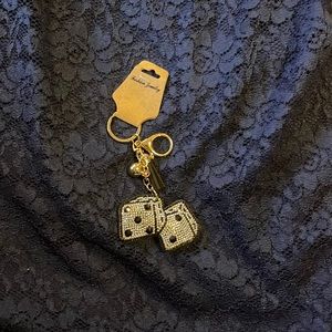 Purse charm black with small silver stones in the shape of dice w/gold hardware.